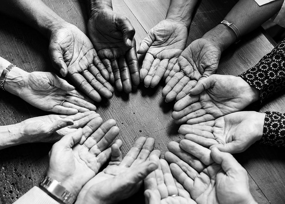 a circle of people joining hands