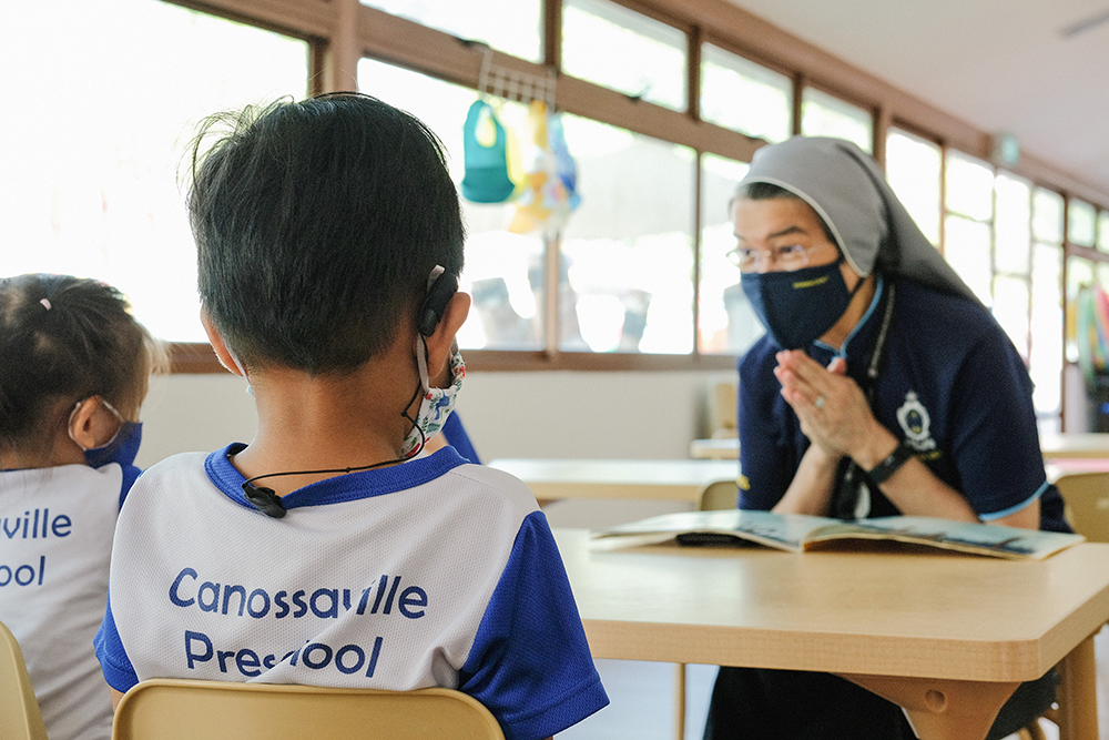 catholic nun teaching children in a classroom from Canossaville Preschool